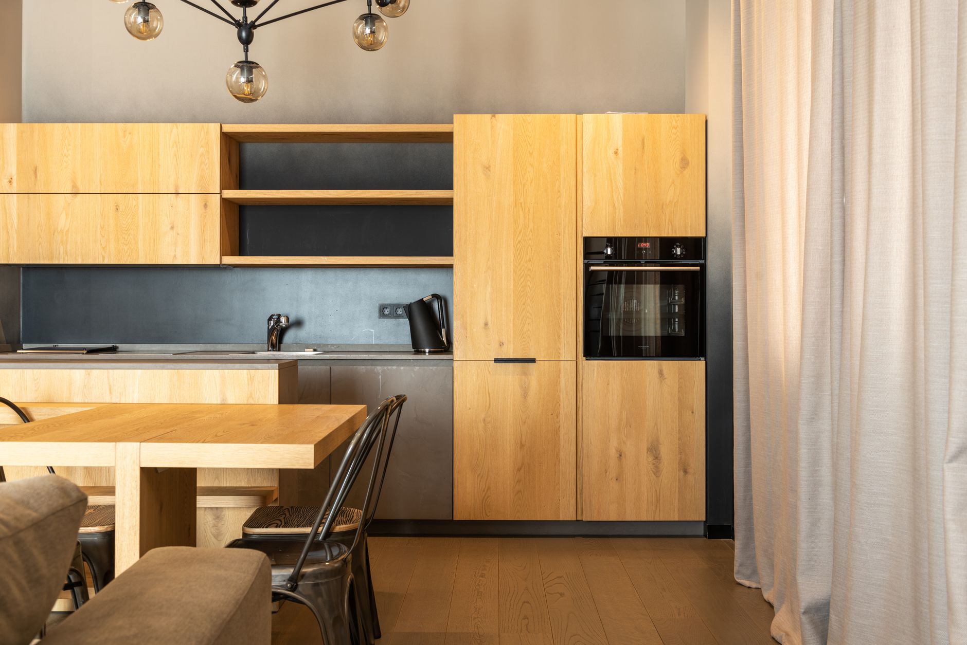 La misma cocina reformada, con muebles de madera y horno nuevo